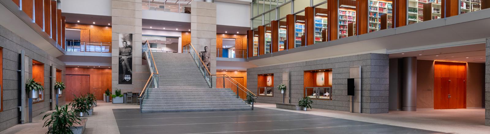 photograph of Library of Virginia lobby with central staircase and library shelving