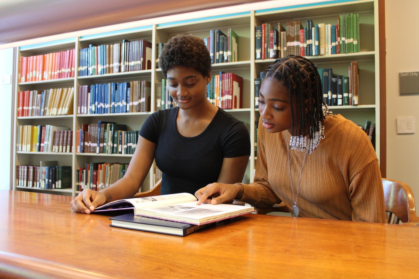 two researchers looking at a book in the Library of Virginia reading rooms